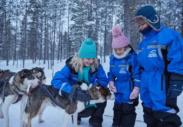 family laughing together in snow