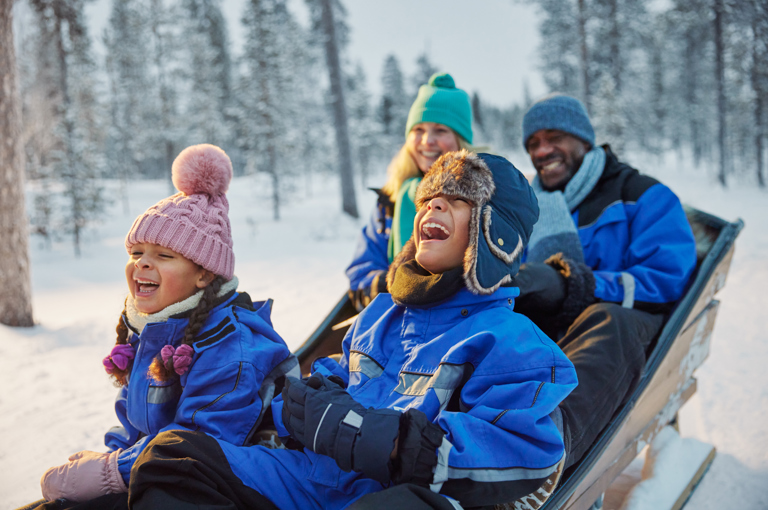 family laughing together in snow