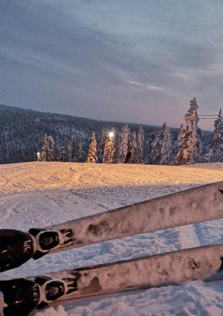 sitting in snowshoes at sunset