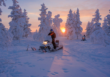 snowmobile ride at sunset